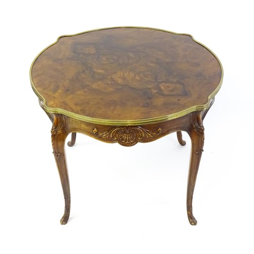 1341 - A late 19thC / early 20thC walnut centre table with a shaped top and a gilt surround, the table havi... 