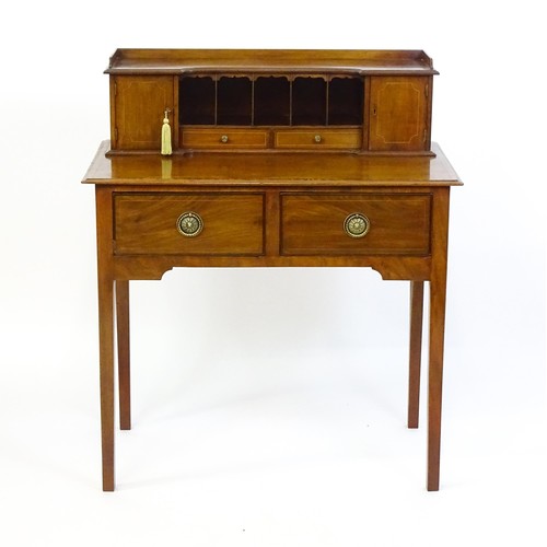 1342 - A late 19thC mahogany writing desk with pigeon holes, cupboards and drawers mounted above a crossban... 