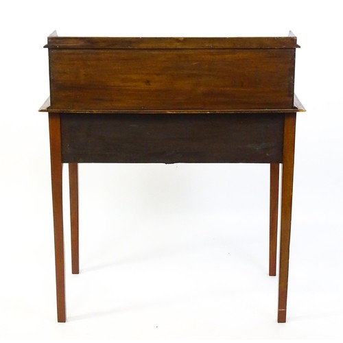 1342 - A late 19thC mahogany writing desk with pigeon holes, cupboards and drawers mounted above a crossban... 