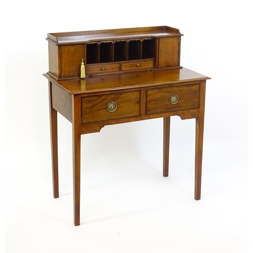 1342 - A late 19thC mahogany writing desk with pigeon holes, cupboards and drawers mounted above a crossban... 