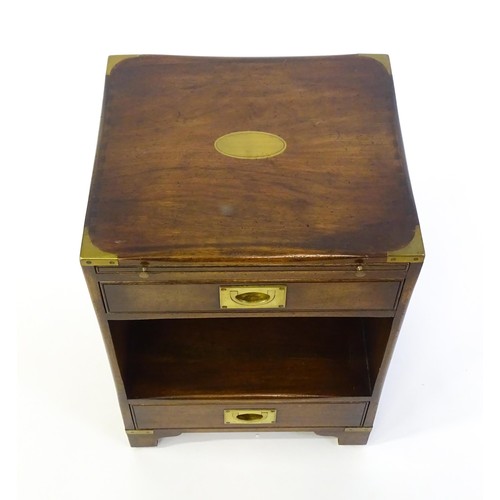 1344 - A mid / late 20thC campaign style cabinet with brass mounted corners, a pull out slide, and two shor... 