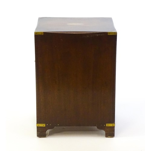 1344 - A mid / late 20thC campaign style cabinet with brass mounted corners, a pull out slide, and two shor... 