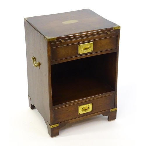 1344 - A mid / late 20thC campaign style cabinet with brass mounted corners, a pull out slide, and two shor... 