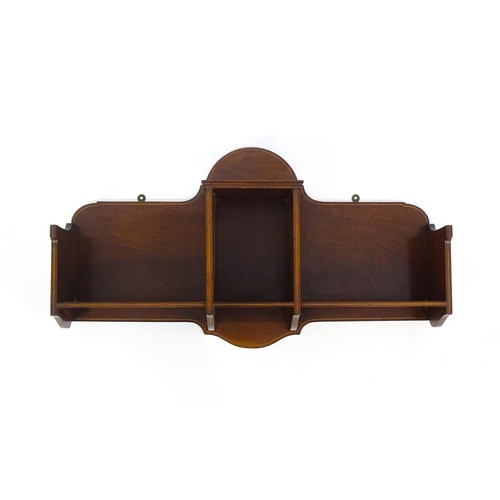 1345 - An Edwardian mahogany hanging wall shelf with decorative satinwood inlay. Bearing label to reverse. ... 