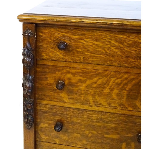 1346 - A Victorian oak Wellington chest, with a moulded top above five graduated drawers with stylised acor... 