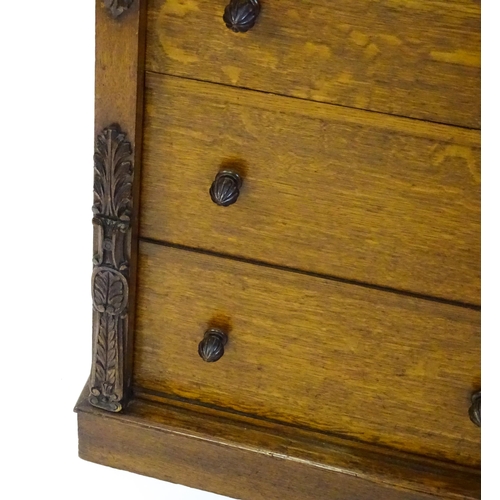 1346 - A Victorian oak Wellington chest, with a moulded top above five graduated drawers with stylised acor... 