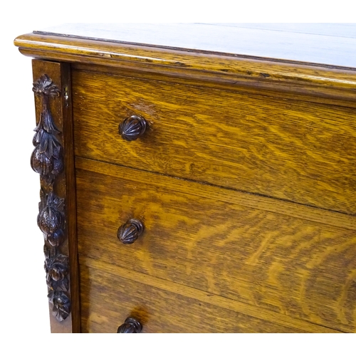 1346 - A Victorian oak Wellington chest, with a moulded top above five graduated drawers with stylised acor... 