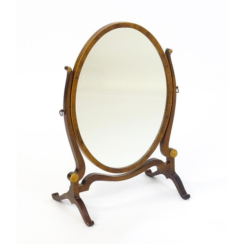 1347 - An early 20thC walnut skeleton mirror with a burr veneered frame and applied roundels. 16