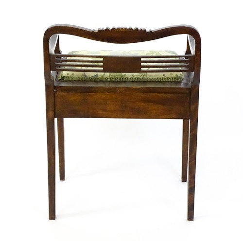 1348 - An early 20thC piano stool with a shaped, carved backrest, pierced back splat and a hinged upholster... 