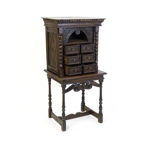 1349 - A Victorian oak cabinet on stand. A 19thC table cabinet with carved lozenge decoration , six short d... 