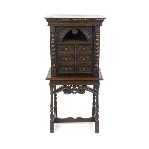 1349 - A Victorian oak cabinet on stand. A 19thC table cabinet with carved lozenge decoration , six short d... 