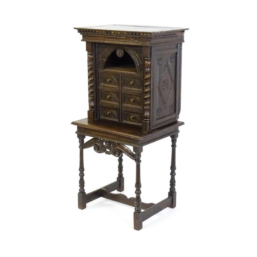 1349 - A Victorian oak cabinet on stand. A 19thC table cabinet with carved lozenge decoration , six short d... 