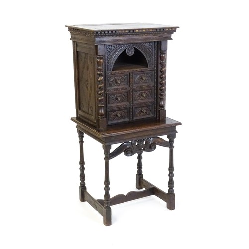 1349 - A Victorian oak cabinet on stand. A 19thC table cabinet with carved lozenge decoration , six short d... 