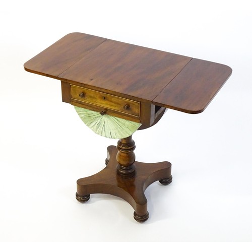 1355 - A 19thC mahogany work table with two drop leaves above a single short drawer with a fitted interior ... 