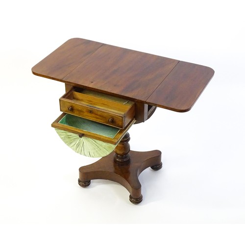 1355 - A 19thC mahogany work table with two drop leaves above a single short drawer with a fitted interior ... 