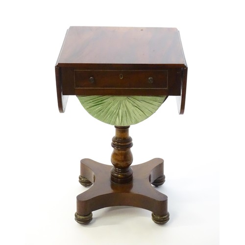 1355 - A 19thC mahogany work table with two drop leaves above a single short drawer with a fitted interior ... 