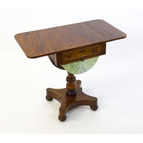 1355 - A 19thC mahogany work table with two drop leaves above a single short drawer with a fitted interior ... 