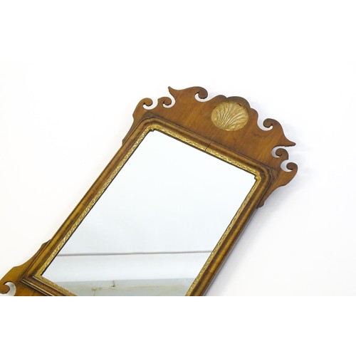 1356 - A mid 20thC George III style walnut mirror with a gilt shell and gilt moulded decoration. 16