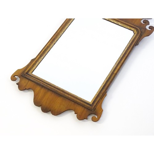 1356 - A mid 20thC George III style walnut mirror with a gilt shell and gilt moulded decoration. 16