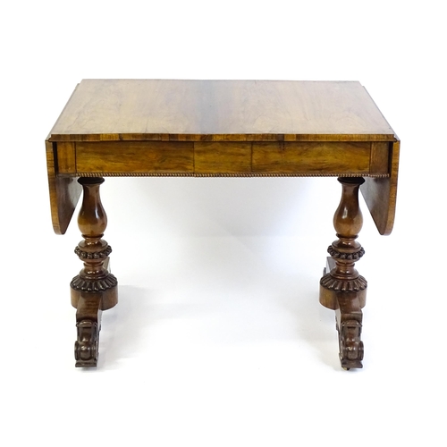 1358 - An early / mid 19thC rosewood sofa table, with drop flaps to either side and two frieze drawers with... 