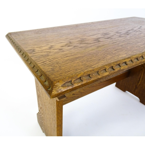 1359 - An oak Cotswold school nest of tables with carved edges, shaped supports and H - stretchers. 28