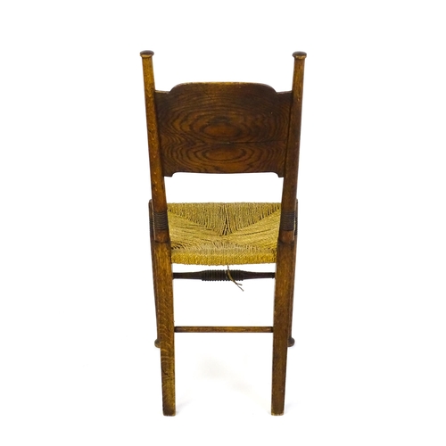 1361 - An Arts & Crafts chair designed by William Birch of High Wycombe, with turned tapering uprights and ... 