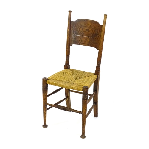 1361 - An Arts & Crafts chair designed by William Birch of High Wycombe, with turned tapering uprights and ... 