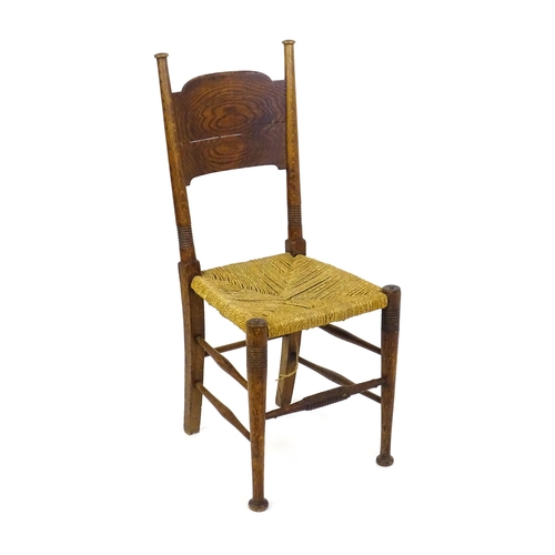 1361 - An Arts & Crafts chair designed by William Birch of High Wycombe, with turned tapering uprights and ... 