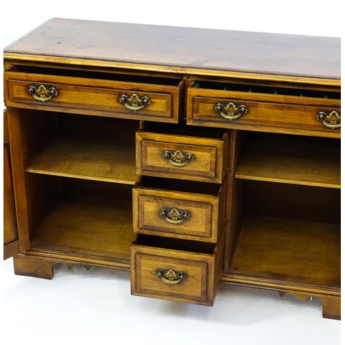 1364 - A 20thC sideboard / dresser base with a crossbanded top and two long over three short drawers flanke... 