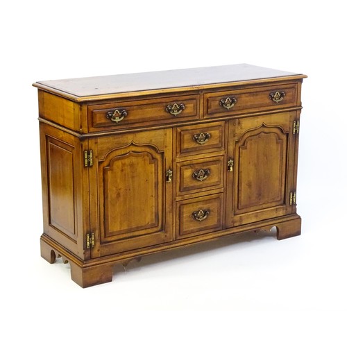 1364 - A 20thC sideboard / dresser base with a crossbanded top and two long over three short drawers flanke... 