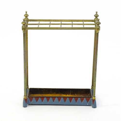 1365 - A late 19thC brass stick stand surmounted by turned finials and with twelve sections above a drip tr... 