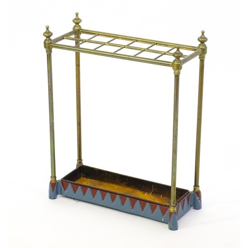 1365 - A late 19thC brass stick stand surmounted by turned finials and with twelve sections above a drip tr... 