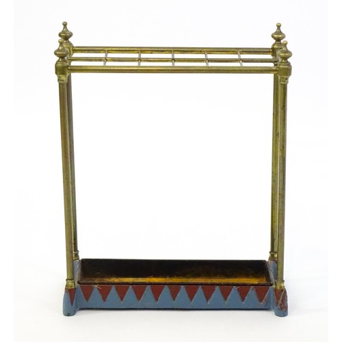 1365 - A late 19thC brass stick stand surmounted by turned finials and with twelve sections above a drip tr... 