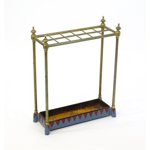 1365 - A late 19thC brass stick stand surmounted by turned finials and with twelve sections above a drip tr... 