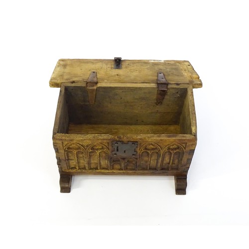 1366 - A 17thC and later bible box with a hinged lid, lancet carved front and raised on later shaped feet. ... 