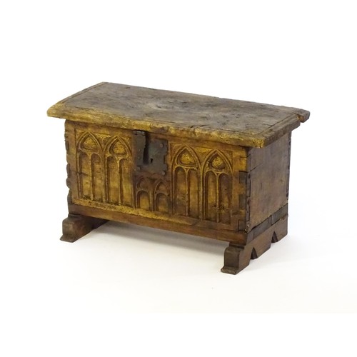 1366 - A 17thC and later bible box with a hinged lid, lancet carved front and raised on later shaped feet. ... 