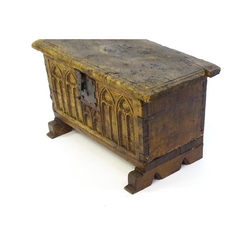 1366 - A 17thC and later bible box with a hinged lid, lancet carved front and raised on later shaped feet. ... 