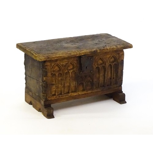 1366 - A 17thC and later bible box with a hinged lid, lancet carved front and raised on later shaped feet. ... 