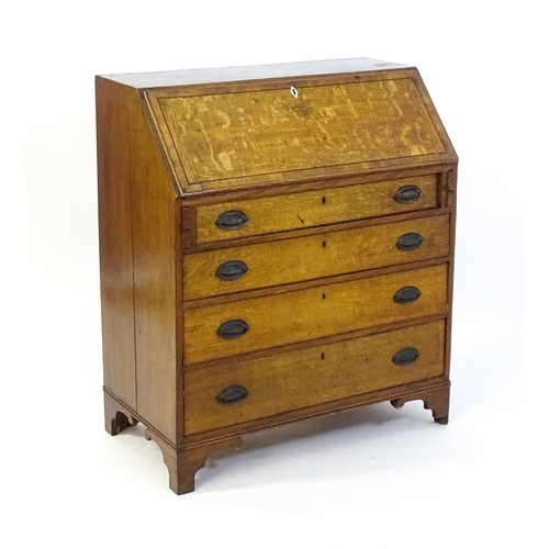 1372 - An 18thC oak bureau with a crossbanded fall front containing a fitted interior with small drawers, c... 