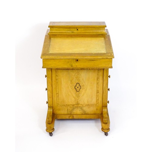 1373 - A late 19thC walnut Davenport with a fitted writing compartment to the top and an inset leather writ... 