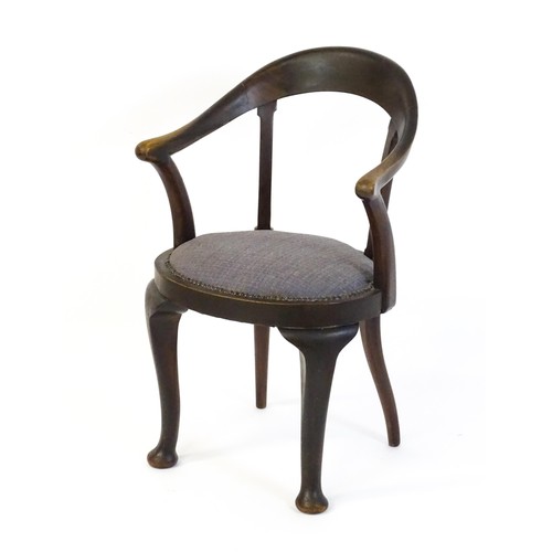 1374 - An early 20thC bow back armchair, with a shaped and bowed top rail above a circular seat and raised ... 