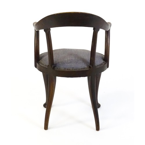 1374 - An early 20thC bow back armchair, with a shaped and bowed top rail above a circular seat and raised ... 