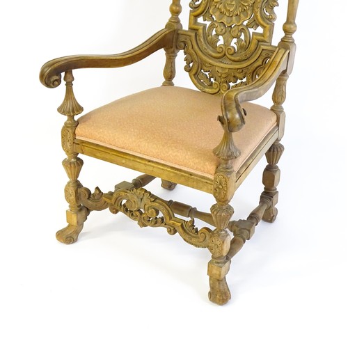 1378 - A 20thC Carolean style armchair, with a carved and pierced backrest, floral decoration, turned taper... 