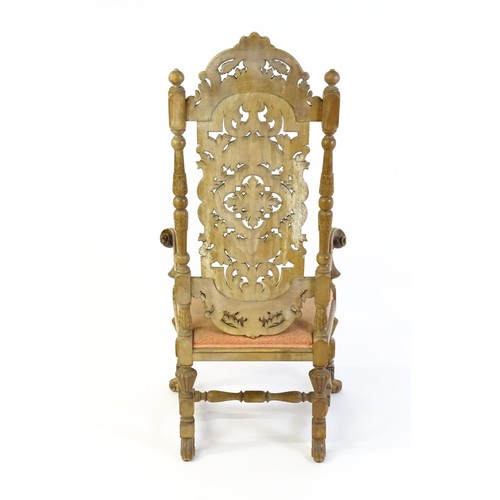 1378 - A 20thC Carolean style armchair, with a carved and pierced backrest, floral decoration, turned taper... 