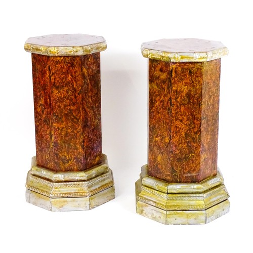 1379 - A pair of mid 20thC columns of octagonal form with silver painted capitals and bases. 18