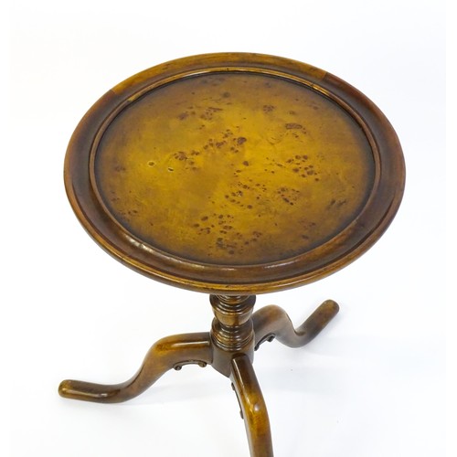 1380 - A 20thC tripod table with a burr walnut veneered, dished top above a turned pedestal and three cabri... 