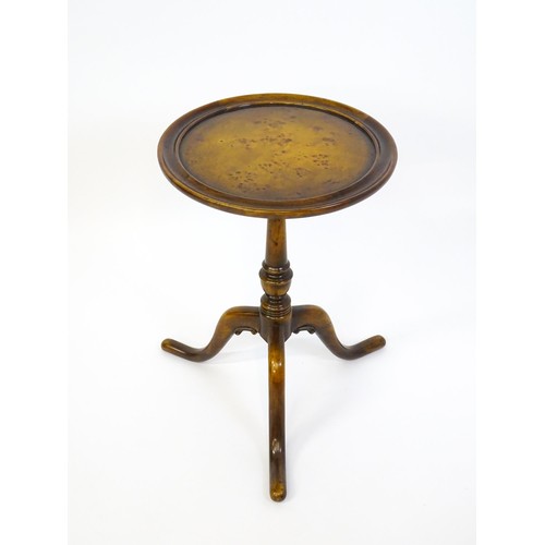 1380 - A 20thC tripod table with a burr walnut veneered, dished top above a turned pedestal and three cabri... 