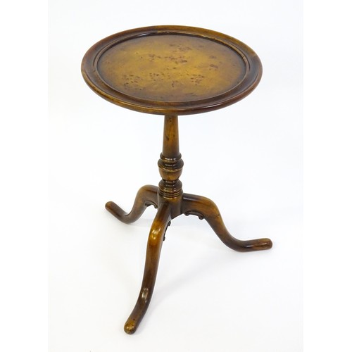 1380 - A 20thC tripod table with a burr walnut veneered, dished top above a turned pedestal and three cabri... 