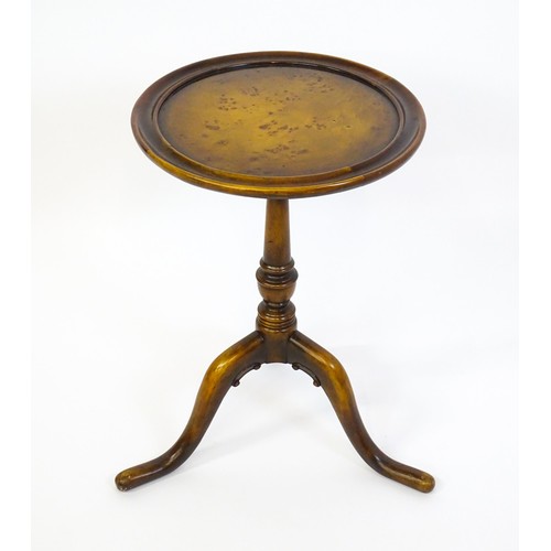 1380 - A 20thC tripod table with a burr walnut veneered, dished top above a turned pedestal and three cabri... 