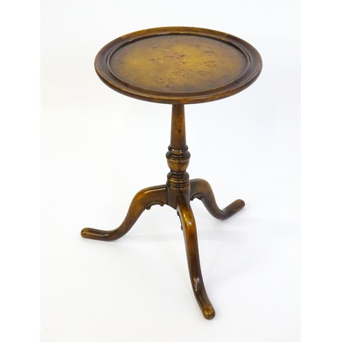 1380 - A 20thC tripod table with a burr walnut veneered, dished top above a turned pedestal and three cabri... 